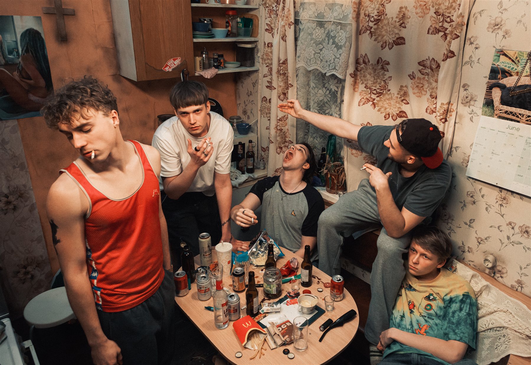 Short film still — ensemble scene in a kitchen